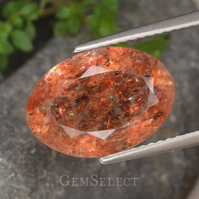 붉은색-주황색 면처리된 태양석 보석