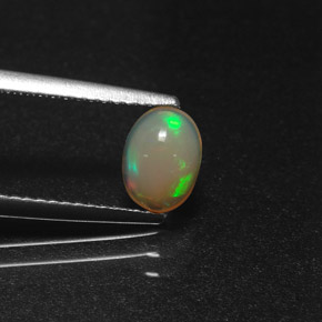0.58캐럿 천연 멀티컬러 오팔, 타원형 컷, 7.1×5.2 mm, 투명한