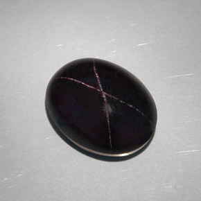 28.81캐럿 천연 붉은빛 블랙 스타 가넷, 타원형 컷, 18.8×14.6 mm, 불투명체