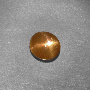 0.79캐럿 천연 골든 브라운 스타 선스톤, 타원형 컷, 6.9×6.4 mm, 불투명체