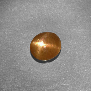 0.79캐럿 천연 골든 브라운 스타 선스톤, 타원형 컷, 6.9×6.4 mm, 불투명체